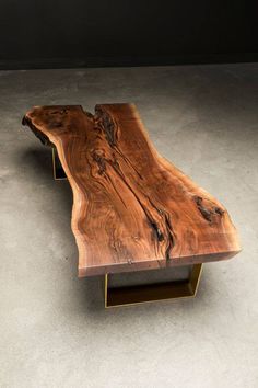 a wooden table sitting on top of a cement floor