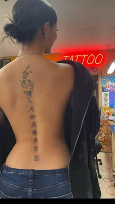 the back of a woman's body with chinese writing on her upper and lower back