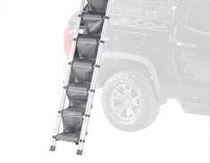 a truck with a ladder attached to it's back end and the front tire