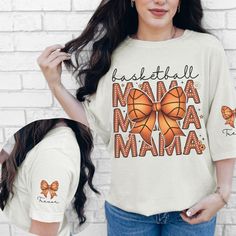 Introducing the Custom Basketball Mama Coquette Doodle Shirt, the perfect way for any sports mom to show off her pride during basketball season! This personalized sleeve print t-shirt is not only stylish but also a great-fitting basketball mom shirt designed for comfort and flair. Whether you're cheering from the bleachers or relaxing at home, this basketball mama tee captures the spirit of game day. It makes an ideal basketball mom gift for Mother's Day or any occasion, allowing you to celebrat Casual Sublimation Custom Print Design For Basketball, Sporty Graphic Print T-shirt For Mother's Day, Sublimation Print Tops For Basketball Fans, Basketball Fan Apparel Tops With Sublimation Print, Fan Apparel Tops With Sublimation Print For Basketball, Team Spirit Graphic Print Tops For Basketball, Basketball Cotton Tops With Screen Print, Casual Basketball T-shirt With Letter Print, Sporty Tops With Basketball Screen Print