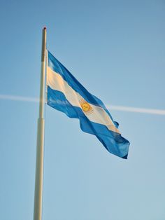 an argentina flag is flying in the wind