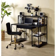 a computer desk with a laptop on top of it next to a potted plant