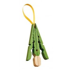 an ornament made out of wooden sticks and green leaves on a white background