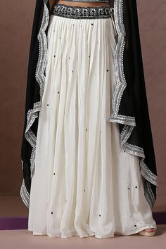 White lehenga with black Kashmiri aari placement embroidery. Paired with square neck embroidered blouse and black dupatta.
Components: 3
Pattern: Embroidery
Type Of Work: Kashmiri aari
Neckline: Square neck
Sleeve Type: Sleeveless
Fabric: Crepe, Georgette, Lining: Cotton
Color: White
Other Details: 
Lehenga:
Embroidered waistband
Length: 40 inches
Approx. weight: 2 kgs
Blouse:
Noodle strap on shoulder sleeve
Dupatta:
Cutwork embroidered borders
Model height: 5ft 7inches, wearing size S
Occasion: Black Dupatta, Noodle Strap, Placement Embroidery, White Lehenga, Pattern Embroidery, Set Women, Cut Work, Embroidered Blouse, Aza Fashion