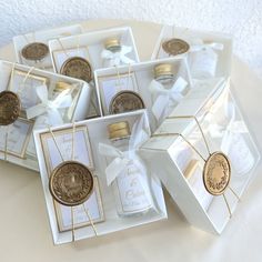 six white and gold gift boxes with one penny in each, the other is empty