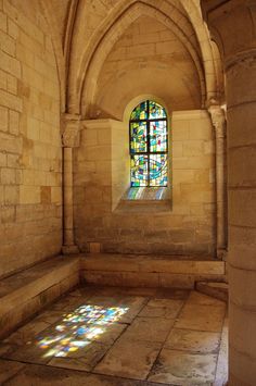 a stained glass window in an old stone building