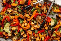 a pan filled with tofu and vegetables on top of a table