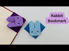 two origami rabbits sitting next to each other with the words rabbit bookmark above them