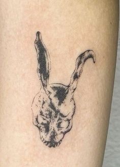 a small rabbit head tattoo on the leg