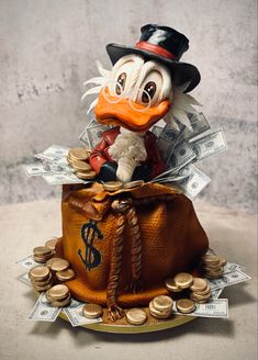 a toy duck in a top hat with money