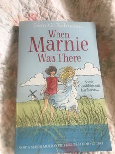 the book when marine was there by joan c robinson is laying on a bed next to a pillow