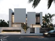 a car driving past a tall white building with palm trees on the side of it