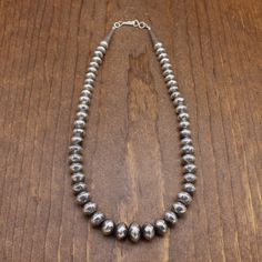 Vintage sterling silver beaded necklace. The graduated beads measure 8.5 to 14 mm in diameter. The necklace measures 17.5" from end to end. It weighs 49.2 grams and is guaranteed to be sterling silver. It is a classic style, beautiful, simple, and in good condition. Thank you for your interest. Please contact us if you have questions. NECK-384EM-NK-17 Southwestern Style Silver Single Strand Necklace, Southwestern Silver Beaded Necklace With Sterling Clasp, Southwestern Silver Necklace With Spacer Beads, Classic Silver Beaded Necklace, Classic Sterling Silver Beaded Necklaces With Polished Beads, Silver Single Strand Artisan Beaded Necklace, Artisan Silver Single Strand Beaded Necklace, Southwestern Silver Jewelry With Spacer Beads, Silver Round Beaded Necklaces Hand-strung