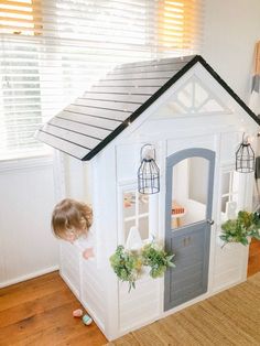 a child is playing in a doll house