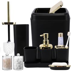 black and gold bathroom accessories including soap dispenser, toothbrush holder, toiletries