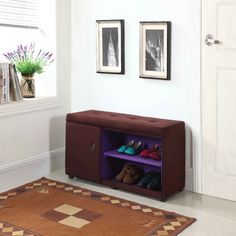 a shoe rack with shoes on it in a room next to a rug and pictures