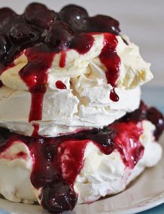 two ice cream sandwiches with cherries and whipped cream drizzled on top