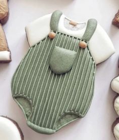 a baby bib and some cookies on a table