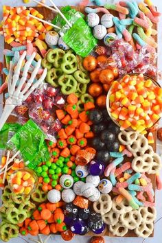 a table topped with lots of candy and pretzels on top of each other