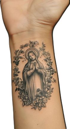 a woman's arm with a tattoo on it that has an image of the virgin mary