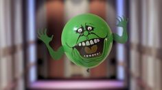 a green balloon with an angry face and hands