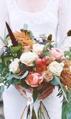 a woman holding a bouquet of flowers in her hands