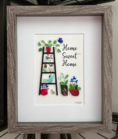 there is a framed picture with flowers and a ladder in the frame that says home sweet home