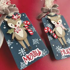 two tags decorated with reindeers and candy canes