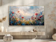 a painting hanging on the wall above a console table with vases and flowers in it