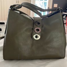 Purchased This Bag Several Years Ago And Just Haven’t Reached For It, So It’s Time For It To Have A New Home! The Color Is Called Olive Grey - More Green Than Grey In My Opinion But A Beautiful Neutral! Approximately 14 In Wide; 11 Tall; 5 Deep Includes Dust Bag Designer Hobo Bag With Detachable Strap And Round Handle, Designer Satchel Hobo Bag For Daily Use, Designer Hobo Tote Bag, Designer Office Hobo Shoulder Bag, Luxury Green Hobo Bag With Detachable Handle, Everyday Bag With Magnetic Closure And Round Handle, Designer Green Shoulder Bag With Leather Handles, Designer Hobo Bag Satchel For Office, Green Coach Designer Bag