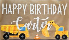 a birthday sign with construction vehicles painted on it