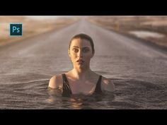 a woman floating in the middle of a road with water on her face and body