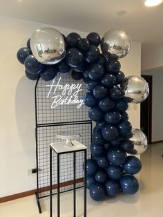 balloons are arranged in the shape of a happy birthday arch on display at a party