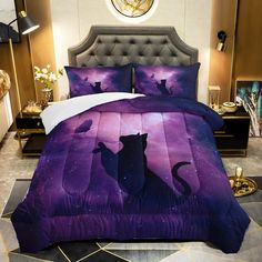 a bed with a purple and black cat design on the comforter, next to a night sky background