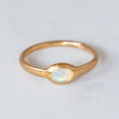 Our ancient inspired Parthian stacking ring is set with an oval crystal opal from Coober Pedy. Opal measures 6 x 4mm. Approx band width 2.6mm - 1.7mm at back of band. Approx weight: 2.3g in silver, 2.5g in 9ct gold. Pictured in first image with a matte finish. For a high shine finish please leave a note at checkout. Please note, we will match the opal as close to the image as possible. Each opal is unique and may vary in appearance and colour from what is depicted on the site. Opal Stacking Ring, Golden Ring, Crystal Opal, Tourmaline Stone, Pretty Rings, My Size, Opal Ring, Opal Crystal, Faceted Crystal