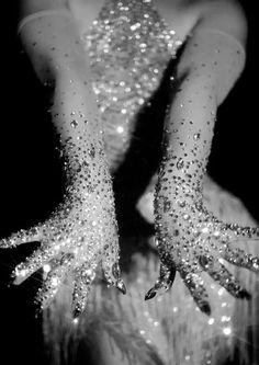 black and white photograph of woman's hands covered in glitter