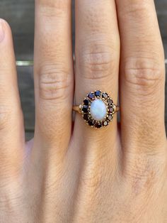 Total Weight: 2.9 grams Size: 6.75 Band Width: 1.4-4.2mm Ring Face: 14.2x12.2mm Opal: 7.7x5.8mm Cubic Zirconia: 2mm Condition: In great condition showing little wear with no damage. All gold has been thoroughly checked with an Olympus XRF spectrometer. It is guaranteed 14k gold.  All our jewelry is properly washed and disinfected to ensure customers get clean items with every order.  Returns accepted but may be subjected to a restock fee.  Please message with any questions:) 14k Gold Birthstone Cluster Ring, Classic White Oval Ruby Ring, White Cluster Ring Stamped 14k, 14k Gold Cluster Ring With Birthstone, Heirloom Cluster Jewelry For Gifts, Heirloom Cluster Jewelry As Gift, Heirloom Cluster Jewelry Gift, Fine Jewelry Cluster Halo Ring Gift, White Ruby Ring In 14k Gold