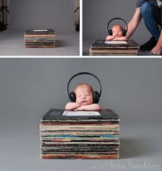 a baby is sitting in a chair with headphones on, surrounded by stacks of books