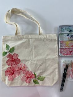 Hand painted with watercolors and sealed with a clear enamel spray. The canvas tote bag measures 15.7"W x 14.9"H, with an inner pocket size of 7.8"W x 7.8"H. Both the main body and inner pocket of the tote bag feature high-quality zippers, providing added storage and security. Cheap Hand Painted Canvas Bag For Daily Use, Cheap Hand Painted Shoulder Bag For Everyday Use, Flower Painting Tote Bag, Tot Bag Painting, Paint On Canvas Bag, Toat Bag Painting Ideas, Painting Ideas Tote Bag, Bag Painting Design, Toat Bag Painting