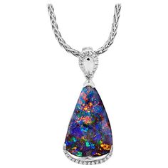 "Moonlight Serenade" opal pendant carries a multi-coloured Australian opal (8.22ct) suspended above a line of diamonds (0.11ct) in an 18K white gold setting. The playfully domed enhancer bale framed with sparkly diamonds is reminiscent of the Moon's water reflections. It allows for the pendant to be attached to a string of small pearls. Suitable for strong fun personas, it can be matched with diamond jewellery or worn on its own. An impressive anniversary gift, or just because. Designed for Opal Moonlight Serenade, Australian Opal Pendant, Boulder Opal Pendant, Precious Opal, Opal Pendant Necklace, Australian Boulder Opal, Water Reflections, Solid Gold Chains, Opal Color