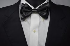 Our rendition of the classic black bow tie. Handcrafted Satin 5 x 2.75 inches with adjustable neck band of  twenty inches. Can be worn, anywhere, anytime, any place, you decide. Classic Adjustable Bow For Business, Adjustable Classic Bow For Business, Classic Bow Tie For Black-tie Events, Classic Adjustable Bow Tie For Black-tie Events, Black Tie Classic Bow Tie, Classic Adjustable Bow With Detachable Feature, Classic Black Bow Tie And Accessories, Classic Black Bow Tie And Suit Accessories, Classic Black Bow Tie Suit Accessories