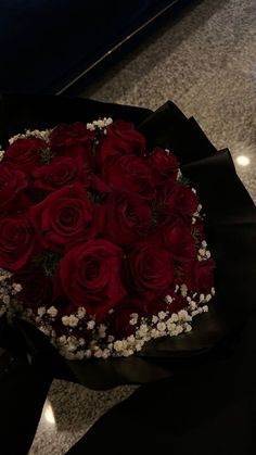 a bouquet of red roses and baby's breath