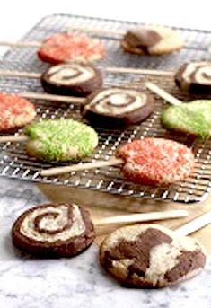 cookies and pastries on a cooling rack with toothpicks in the foreground