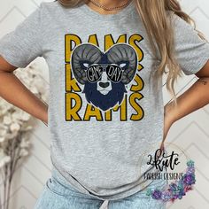 Treat yourself or anyone in your life to this awesome School pride tshirt. This rams school spirit shirt is great for game days!!   Great for all occasions.  And great for supporting your Rams team.  Shirt is made of 95% polyester and 5% spandex. It's soft with great stretch.  To get the best wear from your shirt please  1. Wash with mild detergent  2. Do not use fabric softener  3. Do not use bleach 4. Tumble dry low.  Please enjoy your shirt as I know we have enjoyed all the ones we have made for ourselves!! Please note that every shirt is made to order and normal processing time takes us 5-7 business days to create a shirt and ship out an order; however we strive our very best to get it out sooner!  *some shirts are made by a process called sublimation printing. It is normal if you see Sports Fan Graphic T-shirt For College, Sports Fan Graphic Print T-shirt For College, School Spirit T-shirt For Game Day, Pre-shrunk Fan Apparel T-shirt For Game Day, Tri-blend School Spirit T-shirt For Fans, Fan Apparel Sublimation Design With Team Name, Fan Gear Sublimation Design With Team Name, Football Season Fan Gear T-shirt, Sports Fan T-shirt For Football Season