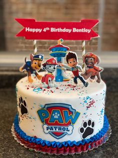 a birthday cake with paw patrol characters on it