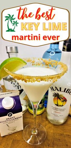 the best key lime martini ever in a margarita glass on a table with ingredients around it