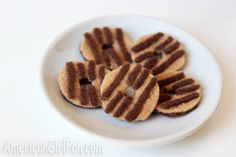 small cookies are arranged on a white plate