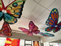 several colorful butterflies are hanging from the ceiling