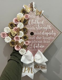 a pink and white graduation cap decorated with flowers