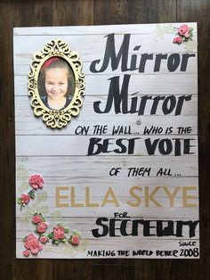 a wooden sign with an image of a child's face and flowers on it